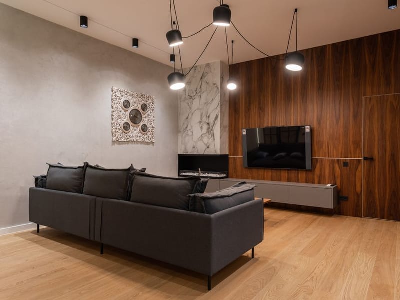 Newly hung feature-wall wallpaper in a Collier Row living room